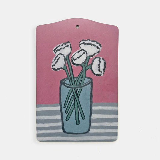 Œillets sur une planche de service rose